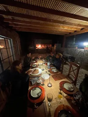 a group of people sitting around a long table at Country House in Azpitia Villa las Leñas in Santa Cruz de Flores