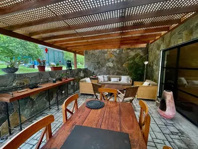 an outdoor patio with a wooden table and chairs at Country House in Azpitia Villa las Leñas in Santa Cruz de Flores