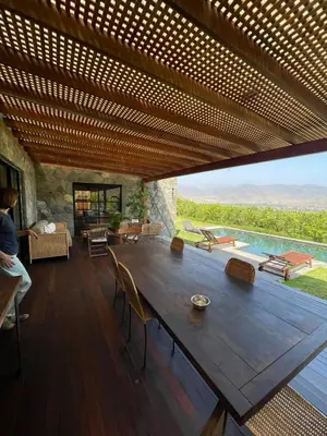 a large wooden table in a living room with a view at Country House in Azpitia Villa las Leñas in Santa Cruz de Flores