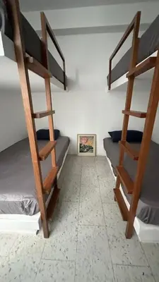 a room with three bunk beds in a room at Casa joyas in Islote Los Leones