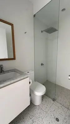 a white bathroom with a toilet and a shower at Casa joyas in Islote Los Leones