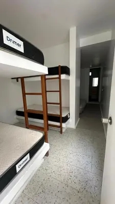 a room with two bunk beds and a hallway at Casa joyas in Islote Los Leones