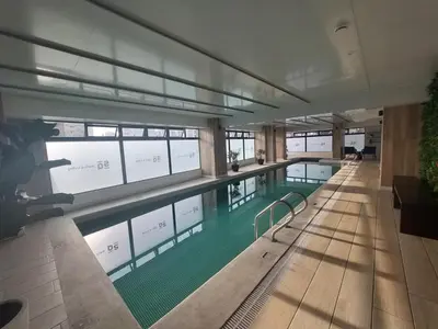 a large swimming pool in a building at Modern Apartment with AC and Pool near Miraflores, Fast WiFi in Lima