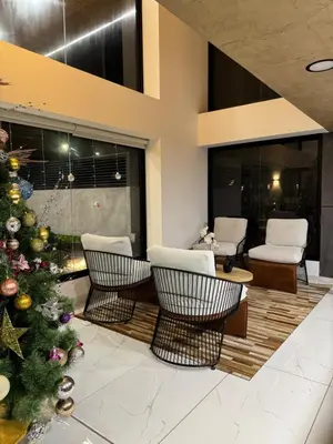 a christmas tree in a living room with chairs at Amalfi Apartment 612 Malecón de la Avenida Costanera in Lima