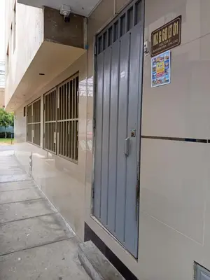 a door to a building with a sign on it at Private Apartment Close to Airport - Airport Shuttle Available in Lima