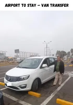 a man is standing next to a white car at Private Apartment Close to Airport - Airport Shuttle Available in Lima