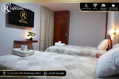 two beds in a hotel room with a sign on the wall at Hotel Rogger in Huancayo