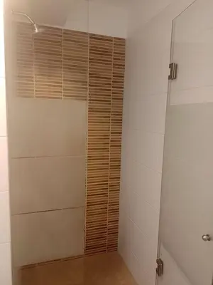a bathroom with a shower with a glass door at Coliving Barranco in Lima