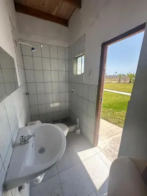 a bathroom with a sink and a toilet and a window at Casita de Campo y Relax con Piscina in Cerro Azul