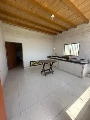 an empty room with a table in a room with a ceiling at Casita de Campo y Relax con Piscina in Cerro Azul