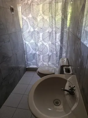 a bathroom with a sink and a toilet at Hostal Ayllu con cochera in Urubamba