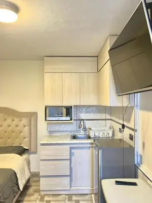 a small kitchen with a sink and a bed at Habitación en Miraflores completa in Lima