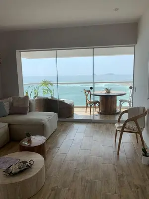 a living room with a view of the ocean at Departamento en Punta Hermosa frente al mar in Punta Hermosa