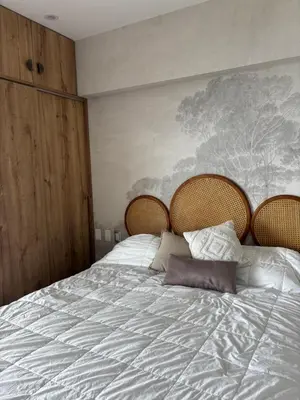 a bedroom with a large bed with white sheets at Departamento en Punta Hermosa frente al mar in Punta Hermosa