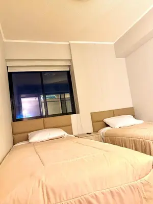 two beds in a room with a window at Brand New Apartment in Lima