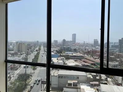 a view of a city from an office window at Departamento céntrico a San Isidro San Borja in Lima