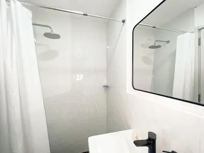 a bathroom with a shower and a sink and a mirror at Departamento céntrico a San Isidro San Borja in Lima