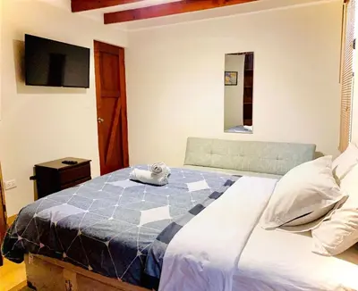 a bedroom with a bed with a stuffed animal on it at Mini Depa Luminoso con Cocina, a Pasos del Parque Kennedy Miraflores in Lima