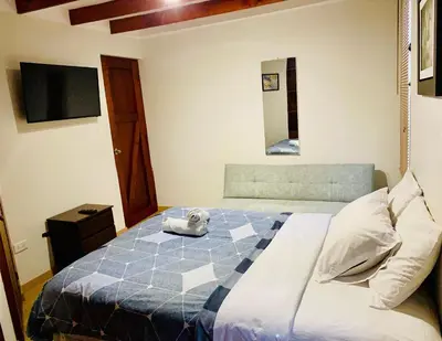 a bedroom with a bed with a stuffed animal on it at Mini Depa Luminoso con Cocina, a Pasos del Parque Kennedy Miraflores in Lima