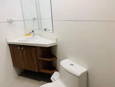 a bathroom with a toilet and a sink and a mirror at Mini Depa Luminoso con Cocina, a Pasos del Parque Kennedy Miraflores in Lima