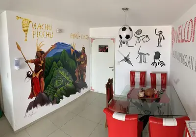 a room with a table and a mural on the wall at Departamento 03 dormitorios cerca Arena 1 in Lima