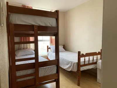 two bunk beds in a room with a window at Departamento 03 dormitorios cerca Arena 1 in Lima