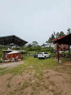 a car parked in a yard next to a building at Cabaña BellaVista in Oxapampa