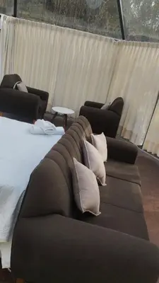 a couch with pillows on it in a room at Cusco Sana Lodge in Cusco