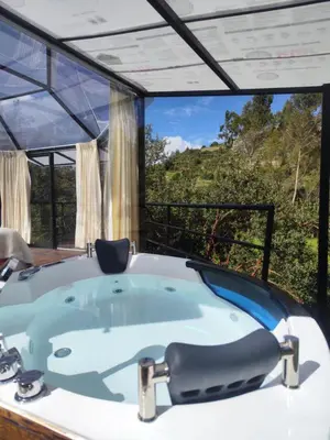 a jacuzzi tub in a room with a view at Cusco Sana Lodge in Cusco