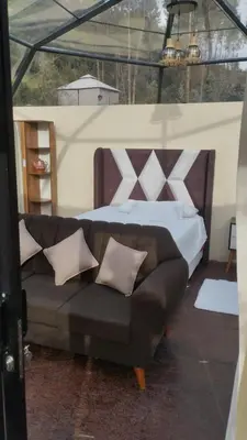a bedroom with a large bed and a couch at Cusco Sana Lodge in Cusco