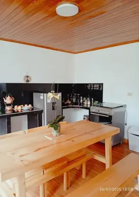 a kitchen with a wooden table in a kitchen at Casa de Campo in Chontabamba