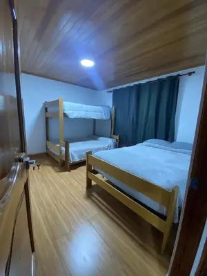 a bedroom with two beds and a bunk bed at Casa de Campo in Chontabamba