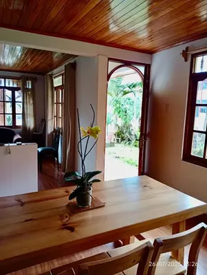 a wooden table with a flower on it in a room at Casa de Campo in Chontabamba