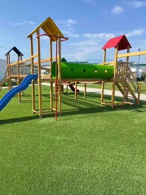 a group of wooden playground equipment in a field at Casa de Playa en Puerto Viejo in Puerto Viejo