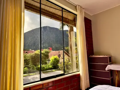 a window with a view of a mountain at Casa Familiar TOVCA Oxapampa in Oxapampa