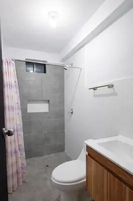 a bathroom with a shower and a toilet and a sink at Posada El Pino
