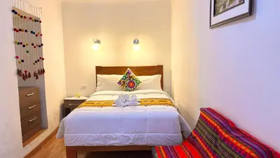 a bedroom with a bed with a bow on it at Horizonte Hotels in Cusco
