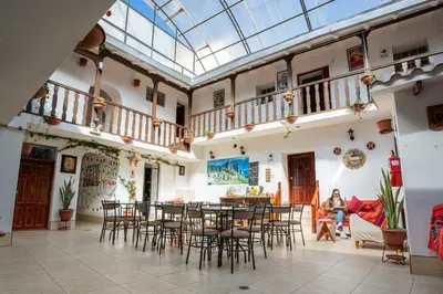 a room with tables and chairs and a glass ceiling at Horizonte Hotels in Cusco