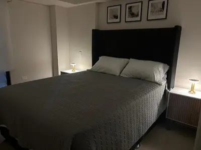 a bedroom with a large bed with two night stands at Apartment in Larco - Miraflores in Lima