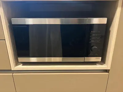 a microwave oven sitting on top of a cabinet at Apartment in Larco - Miraflores in Lima