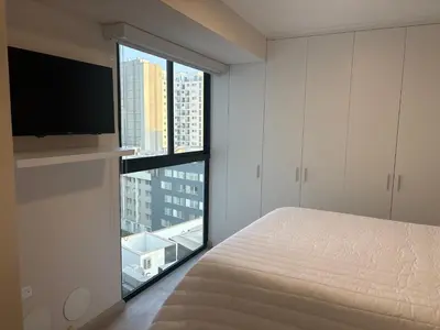 a bedroom with a bed and a large window at Apartment in Larco - Miraflores in Lima