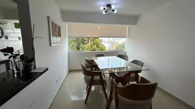 a dining room with a glass table and chairs at Spacious and bright apartment with a beautiful view in Lima