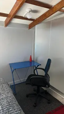 a blue desk in a room with a chair at Cozy room with kitchenette and private bathroom in Cusco