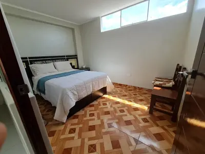 a bedroom with a bed and a window and a wooden floor at comfortable magic apartment in San Juan Bautista