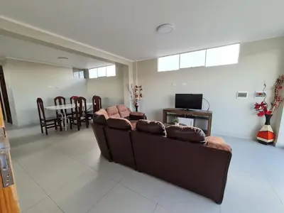 a living room with a brown couch and a table at comfortable magic apartment in San Juan Bautista