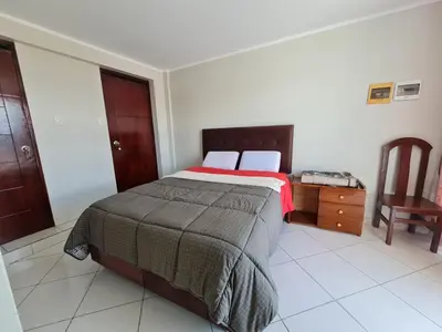 a bedroom with a bed and a table and a chair at comfortable magic apartment in San Juan Bautista