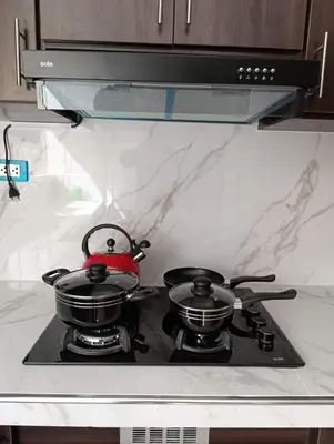 a pair of pots and pans sitting on top of a stove at Sumaq Sky in Cusco