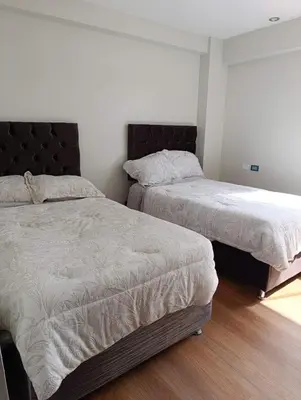 two beds sitting next to each other in a bedroom at Sumaq Sky in Cusco
