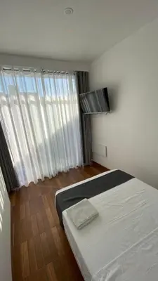 a bedroom with a bed and a large window at Ocean Home in San Juan de Marcona