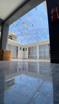 a pool of water with kites hanging from a building at Ocean Home in San Juan de Marcona